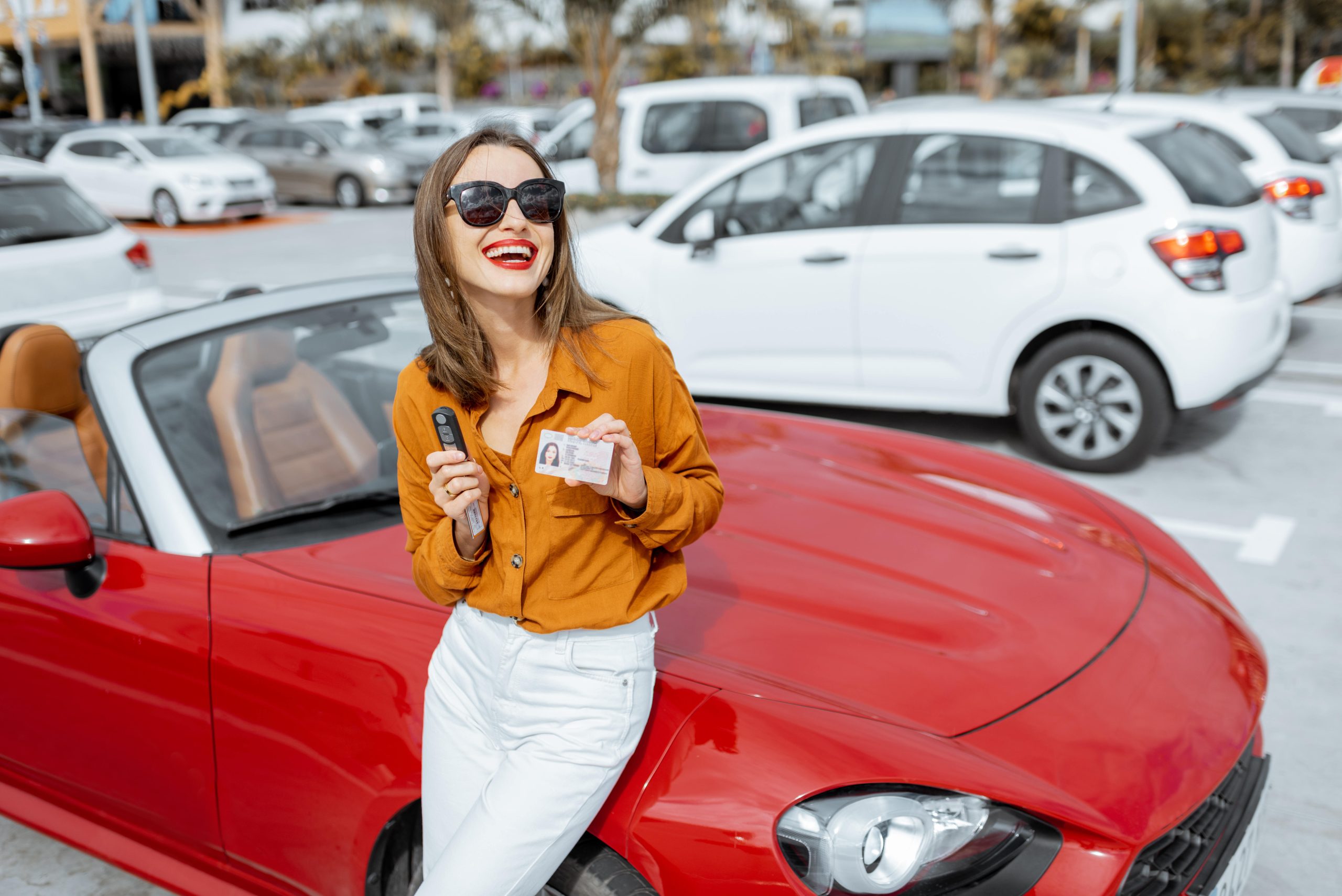 teen driver with license and keys leaning on car | driving schools for new drivers in Parkland, Fl